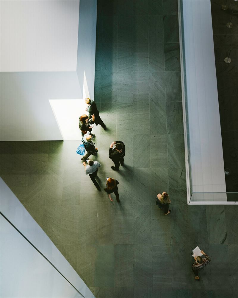 People crossing a large office lobby, seen from above