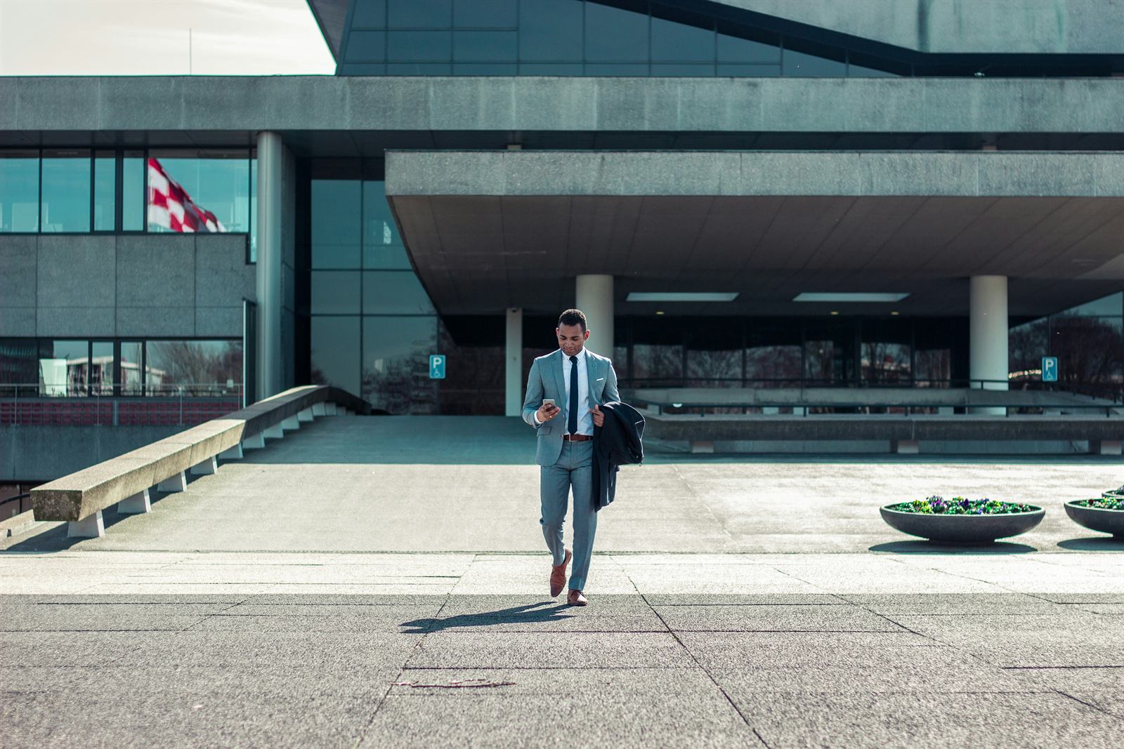 A manager walking out of a modern office building